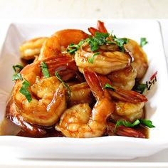 a white plate topped with shrimp covered in sauce