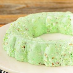 a cake with green frosting sitting on top of a white plate