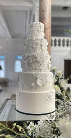 a white wedding cake sitting on top of a table