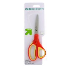 a pair of scissors sitting on top of a package