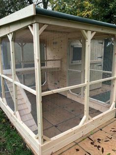 a large bird cage sitting on top of a wooden platform