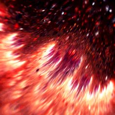 an orange and red firework is seen in this artistic image, with many small stars