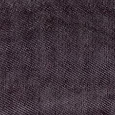 a close up view of a purple fabric textured with small squares and dots on the surface