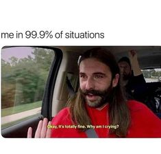 a man with long hair sitting in a car