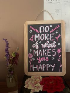 a sign that says do more of what makes you happy next to some vases with flowers