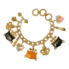 Ritzy Couture Princess Kitty Black & Tabby Multi Charm Toggle Bracelet (Goldtone). We both know your cat is queen of the house. Now you can be ruler of your accessories game with this feline friendly necklace! This bracelet boasts a collection of drop charms including two Fleur-de-Lis, an iridescent heart-shaped charm and several pretty kitties wearing cute princess crowns decorated with clear glass stones. The easy to use toggle makes taking off this bracelet a breeze -- which means more cat time for you! Bracelet adjusts from 7.0", 7.75" to 8.5". Goldtone Double Curb Chain. Charms are detailed front and back. Adjustable. Toggle Bracelet. Measures approximately 7.0" to 8.5" Ritzy Couture by Esme Hecht – Original Designer of Lunch at The Ritz Designed with love in the USA Imported Princess Crowns, Princess Kitty, Cat Bracelet, Couture Accessories, Cute Princess, The Ritz, Cat Charm, Toggle Bracelet, Lucky Clover