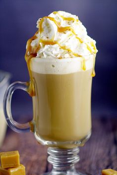 a glass mug filled with whipped cream and caramel