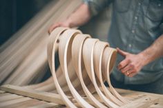 a man working on some wooden pieces