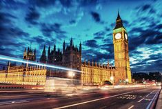 the big ben clock tower towering over the city of london at night with long exposure