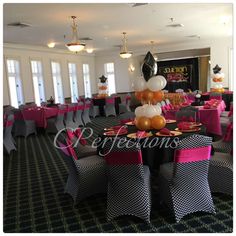 a banquet hall decorated with black, white and gold balloons