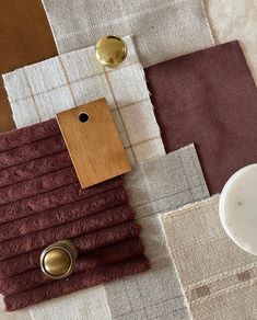 a table topped with lots of different types of cloths and wooden buttons on top of each other