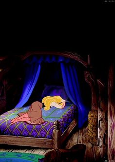 there is a bed in the dark with a princess sleeping on it's side