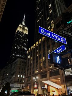 the street signs are clearly visible for all to see in this city at night time