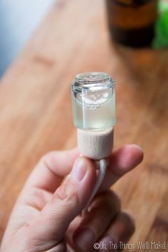 a person holding an empty pill bottle in their hand