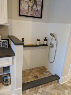 a bathroom with tile flooring and white walls, including a walk - in shower