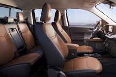 the interior of a vehicle with tan leather seats