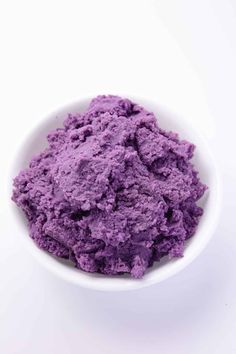 a white bowl filled with purple colored powder