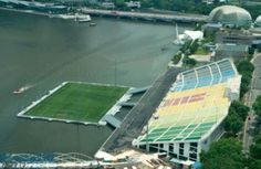 an aerial view of a soccer field next to the water