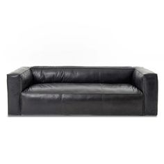 a black leather couch sitting on top of a white floor