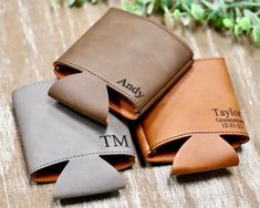 three personalized leather wallets sitting next to each other