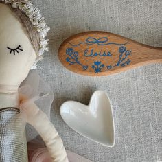 two wooden spoons are next to a doll's head