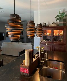 a kitchen with a sink and hanging lights