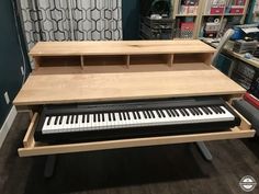 a piano sitting on top of a wooden table in a store next to other items