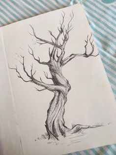 a drawing of a tree with no leaves on the ground next to a blue and white striped table cloth