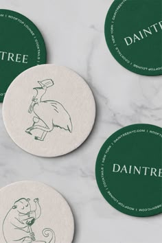 three coasters with green ink on them and the words dantre printed on them