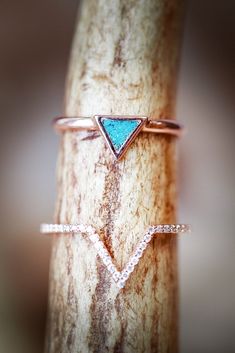 Product Details Ring Style: The "Mera" is a triangle-style turquoise women's engagement ring with a v-shaped diamond stacker. Many other center stone options are available upon request. Center Stone: Triangle Turquoise Materials: 14K rose gold engagement ring featuring a turquoise center stone and an accent diamond stacker Customizable: Because each ring is handcrafted to order, we can customize yours using unique materials, gemstones, or design features, often without any added cost! We can eve Turquoise Engagement Ring, Western Wedding Rings, Turquoise Ring Engagement, Wedding Ring Gold, Antler Wedding, Country Jewelry, Staghead Designs, Cowgirl Jewelry, Turquoise Wedding