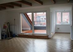 an empty room with sliding glass doors and hard wood flooring on the other side