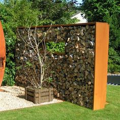 a large wooden sculpture sitting in the middle of a yard next to a tall tree