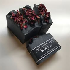 some sort of black box with flowers on it sitting on a table next to a bar of soap