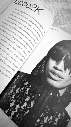 an open book with black and white photos on the pages, featuring a woman's face