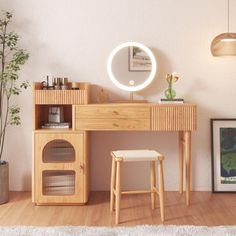 a wooden desk with a mirror, stool and potted plant next to it in a white room