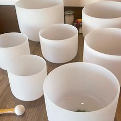 many white cups are lined up on the table