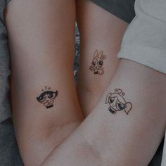 two people with matching tattoos on their arms