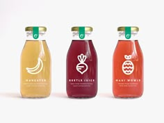 three different types of juice in glass bottles