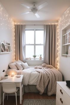 a small bedroom with lights on the ceiling and a bed in front of a window