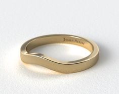 a yellow gold wedding band with an curved design