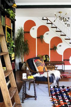 a living room filled with furniture and a staircase leading up to the second floor area