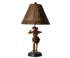 a table lamp with a woman holding a bird on it's arm and wearing a hat