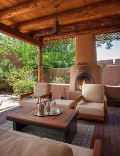 an outdoor living area with couches and tables