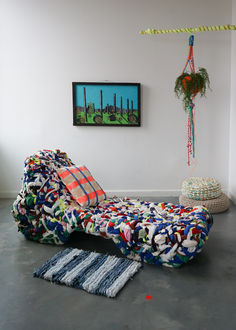 a living room with a couch and rugs on the floor next to a painting