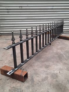 a row of metal railings sitting next to each other on top of cement ground