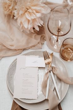 a table setting with place settings and napkins