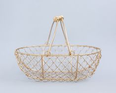 a gold wire basket with two handles