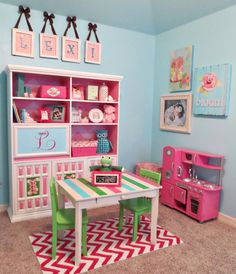 a child's playroom with pink, green and blue furniture