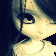 a doll with long black hair and big eyes