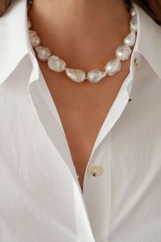 This baroque pearl choker elevates the everyday. A casual statement piece that makes for great layering––you will never want to take it off! Each pearl is unique, and is subject to its own perfect imperfections. Pearl measures approximately 1/2" and is strewn on invisible 15" chain with invisible screw clasp. Made in the U.S.A. * This product is crafted with natural pearls, and variations make each piece unique. Item ships within 1 to 2 weeks and is excluded from ALL discounts Thick Pearl Necklace, Clothes With Pearls, Wedding Pearl Choker, Pearl Jewelry Photography, Pearl Styling, Pearl Jewellry, Pearl Necklace Outfit, Statement Pearl Necklace, How To Wear Pearls